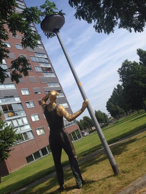 "Golden Man" by André Havas. I guess it would be a bit awkward to have a statue stare at your apartment, but one apparently does get used to it. http://www.flevolanderfgoed.nl/home/kunst/zuidelijk-flevoland/almere/de-gouden-man.html