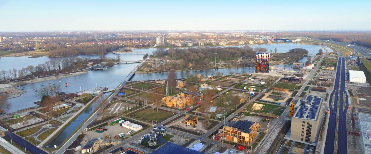 An aerial view of a city with a river, bridges, and industrial areas.