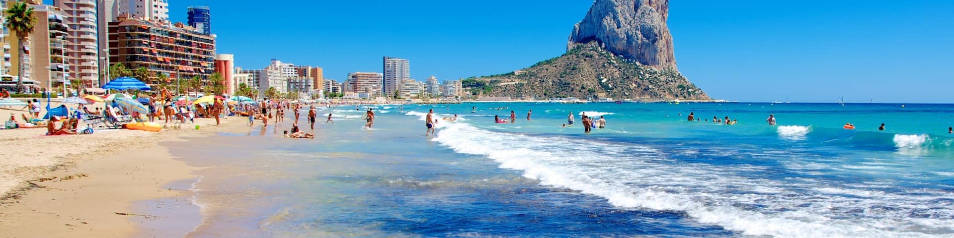 Calpe som inkluderar en sandstrand, berg och vÄgor