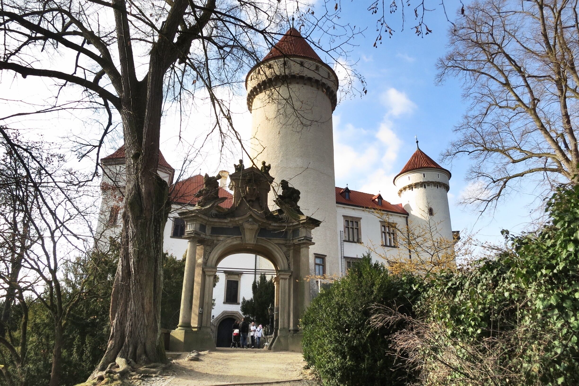 A historic castle with a prominent tower and an ornate entrance archway.