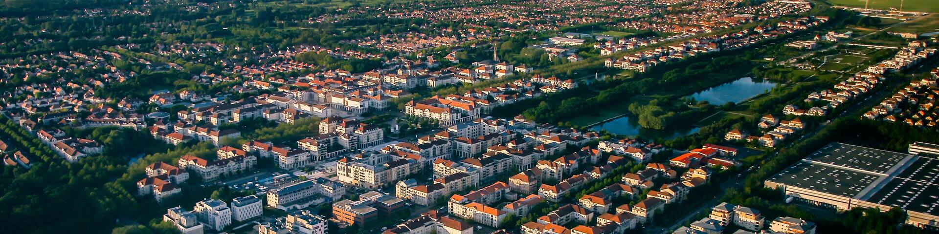 Aerial view of Bussy Saint Georges, an eastern suburb of Paris in the new city of Marne La Vallée - Planned community with a grid street plan and modern residential areas surrounded by nature