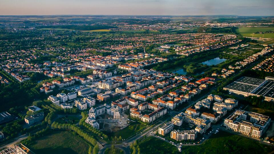 Aerial view of Bussy Saint Georges, an eastern suburb of Paris in the new city of Marne La Vallée - Planned community with a grid street plan and modern residential areas surrounded by nature