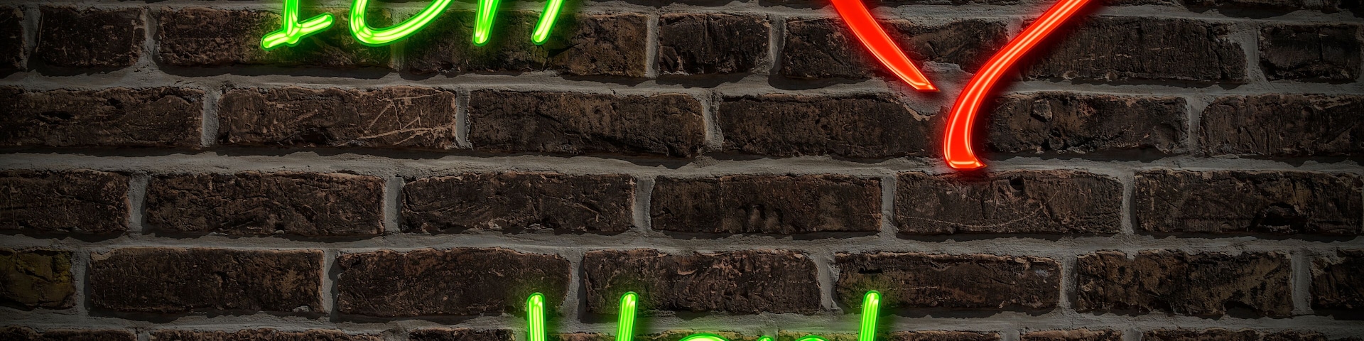 A brick wall with neon signs spelling "Ich Verla" and a red heart.