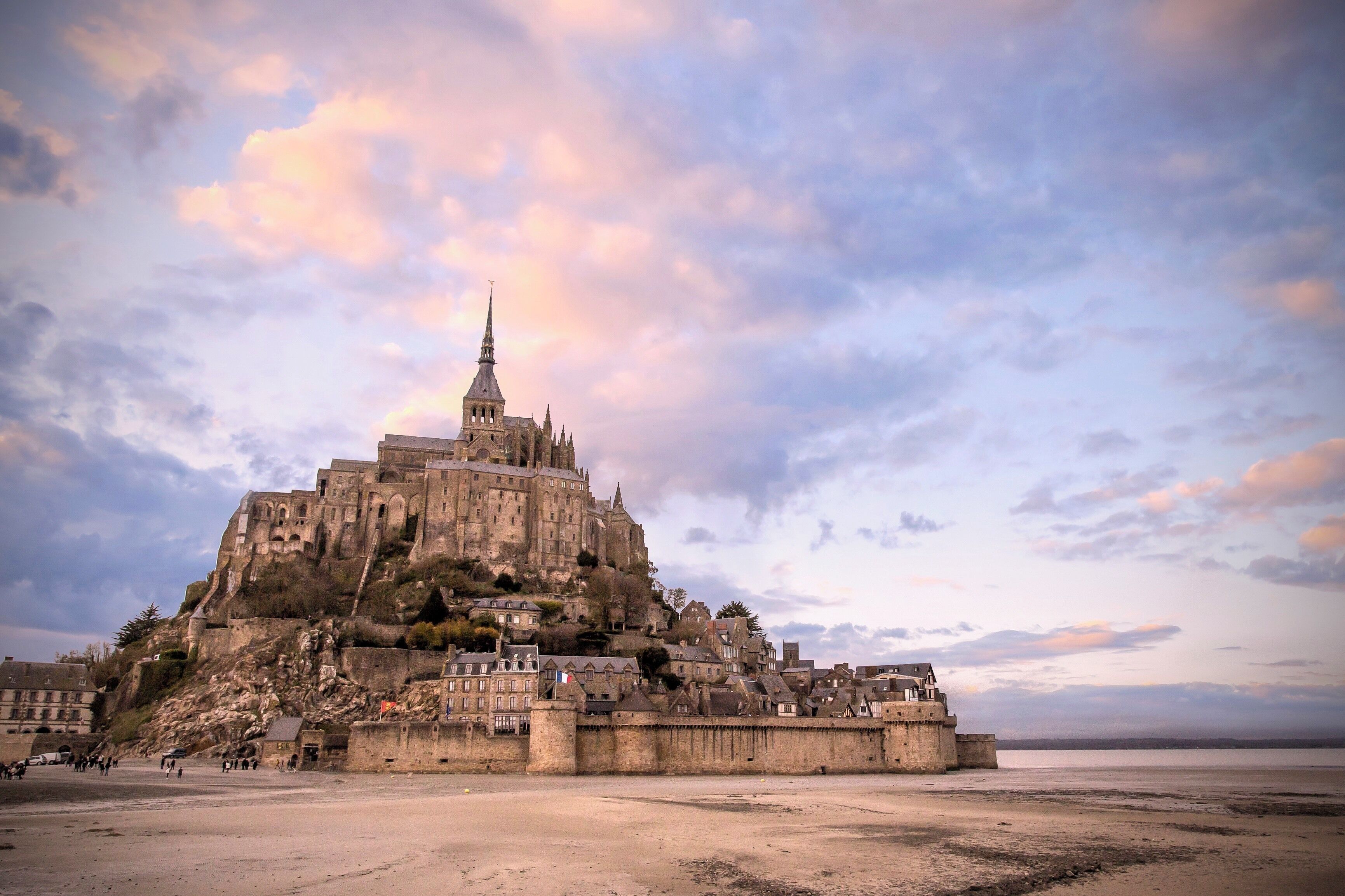Mont St. Michel... From 966 onwards, the dukes of Normandy, followed by French kings, supported the development of this major Benedictine abbey on the Mont-Saint-Michel

This was also the inspiration for Minas Tirith in the Lord of the Rings, Return of the King...