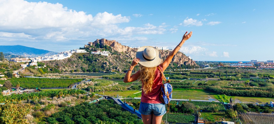 Tourist woman admiring the castle and white houses in Salobreña, Spain, Granada province