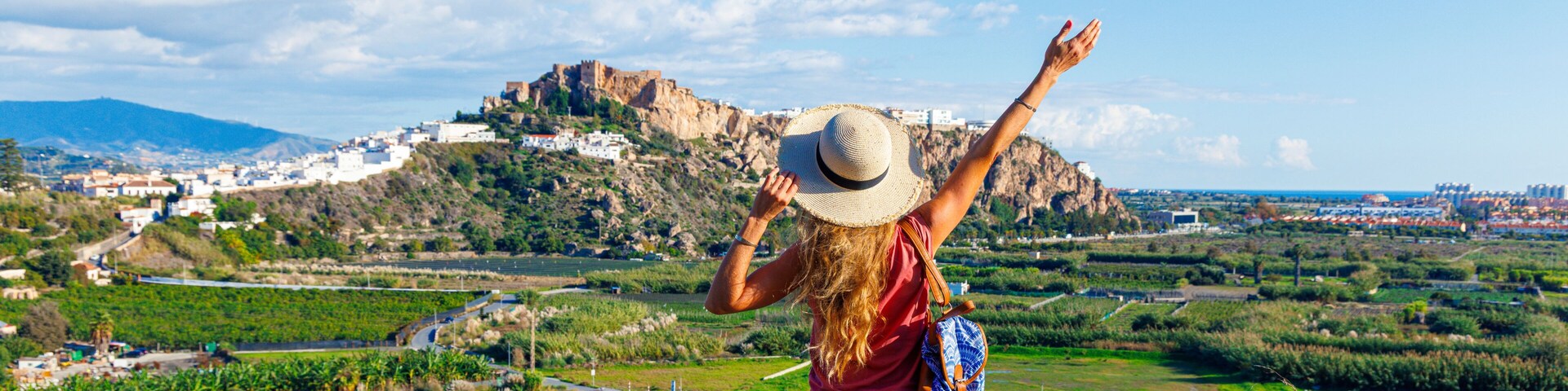 Tourist woman admiring the castle and white houses in Salobreña, Spain, Granada province