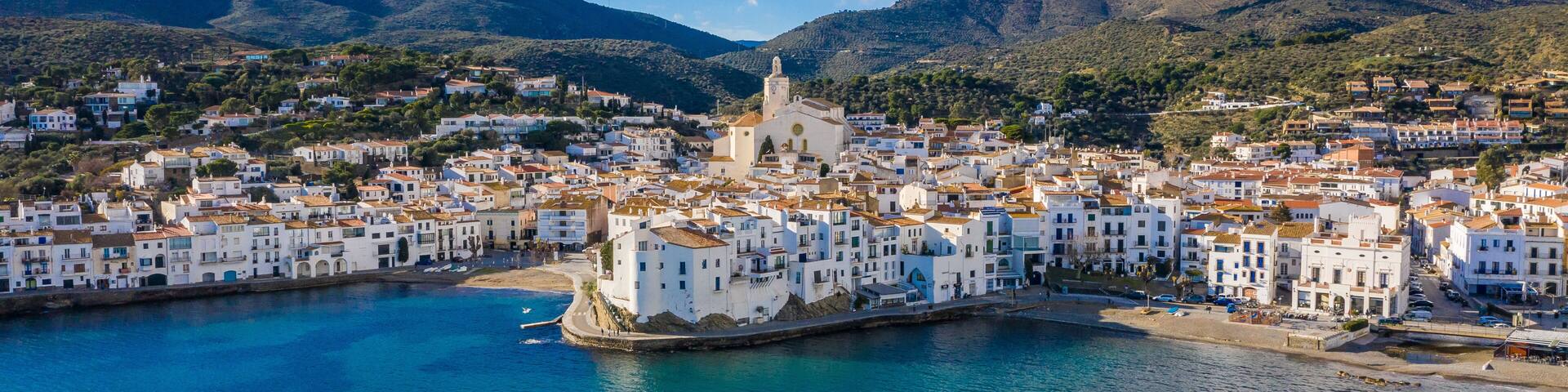 amazing aerial panoramic view photo of Cadaques small cizy city by the sea in Spain. Sunny day and big clouds. Mountains. Nature