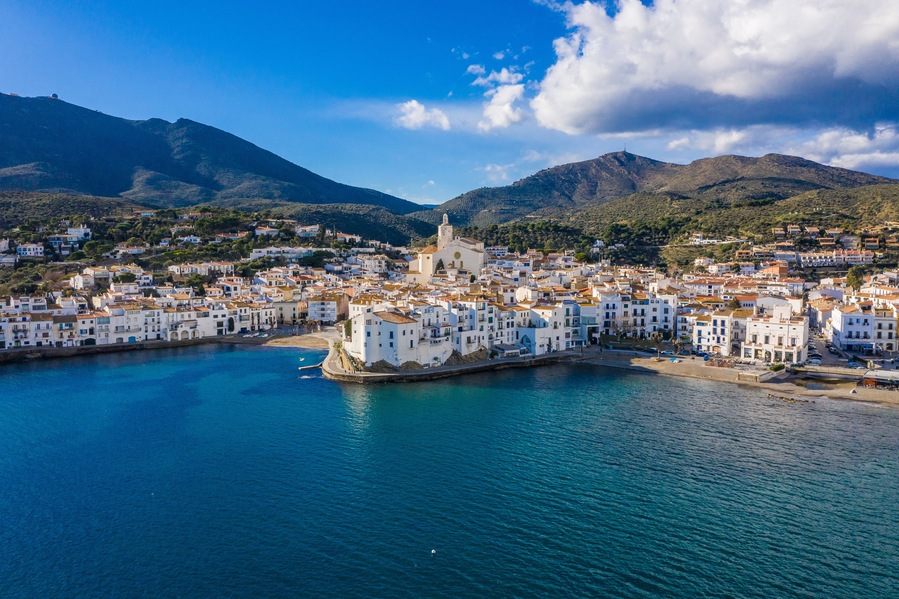 amazing aerial panoramic view photo of Cadaques small cizy city by the sea in Spain. Sunny day and big clouds. Mountains. Nature