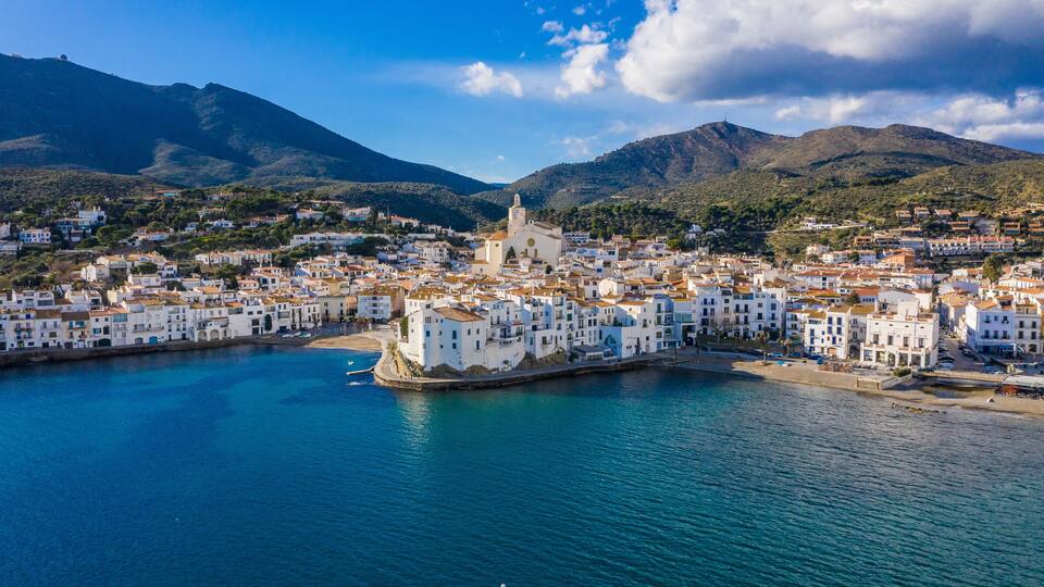 amazing aerial panoramic view photo of Cadaques small cizy city by the sea in Spain. Sunny day and big clouds. Mountains. Nature