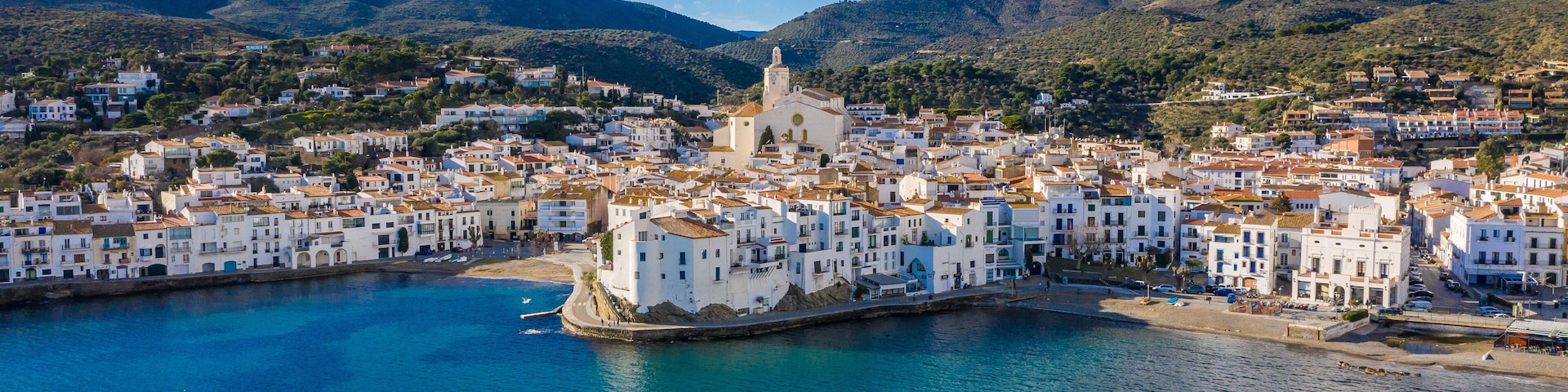 amazing aerial panoramic view photo of Cadaques small cizy city by the sea in Spain. Sunny day and big clouds. Mountains. Nature