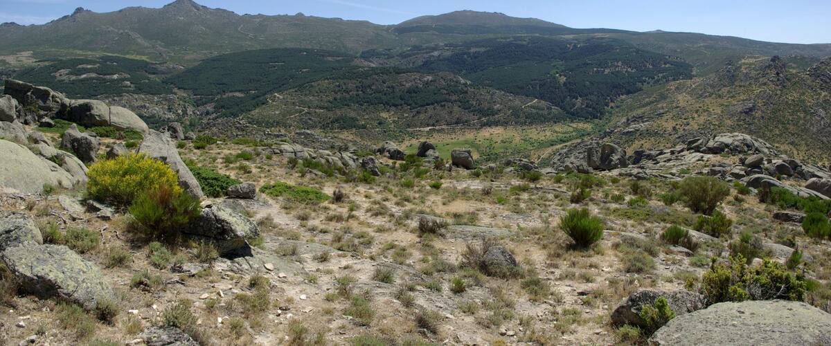 A mountainous landscape with rocky terrain and sparse vegetation.