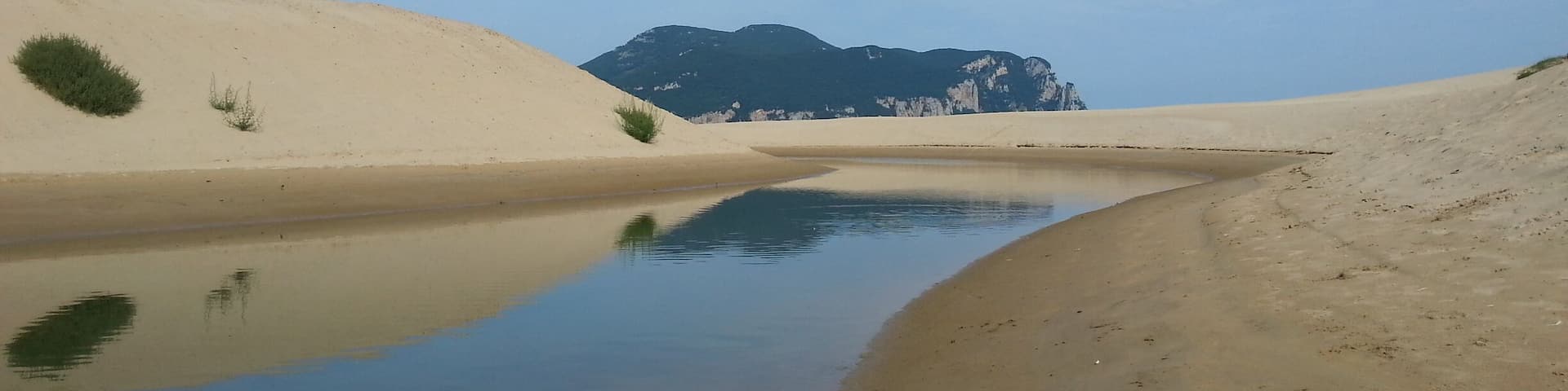 Where the sand meet up the blue sky with a fine line