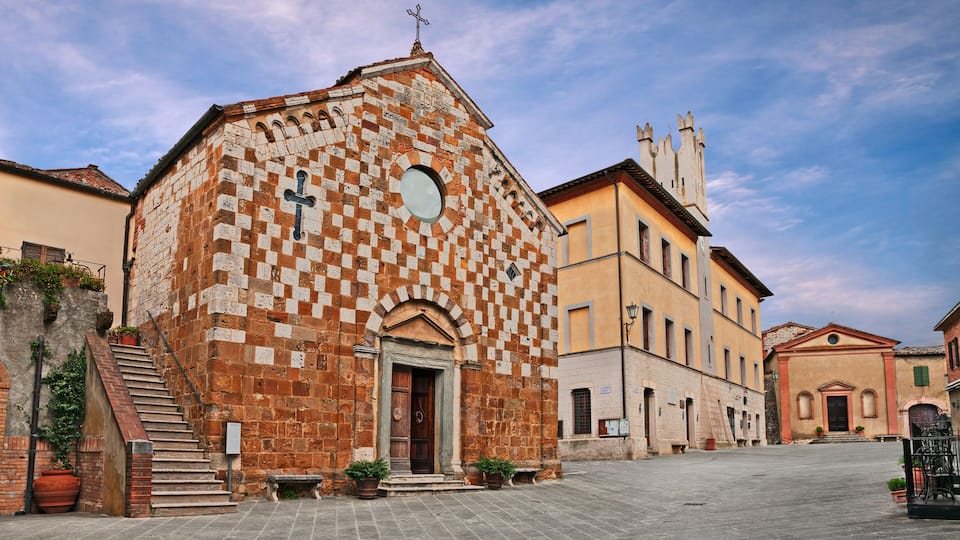 A historic church with a checkered facade and a bell tower.