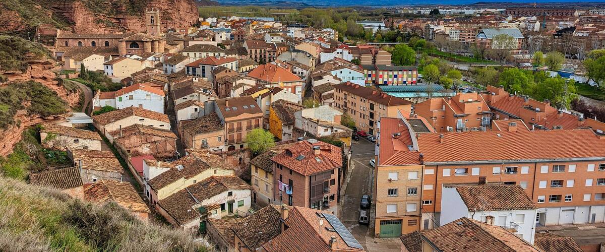 A mountainous town with historic buildings and a prominent church.