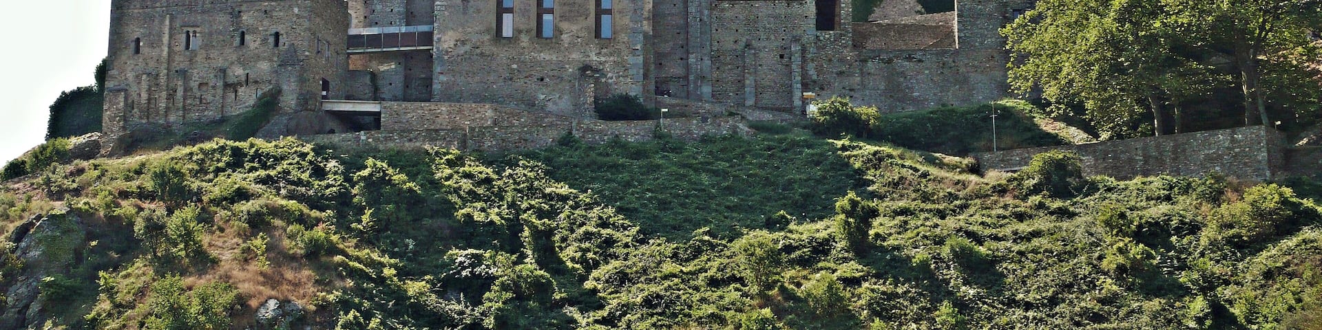 A medieval castle on a hill with multiple towers and battlements.