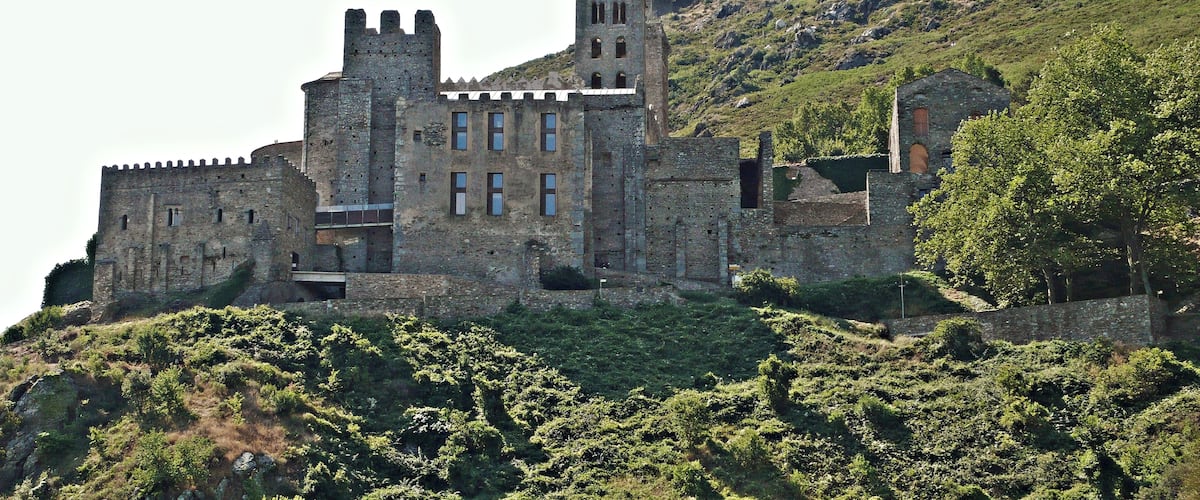 A medieval castle on a hill with multiple towers and battlements.
