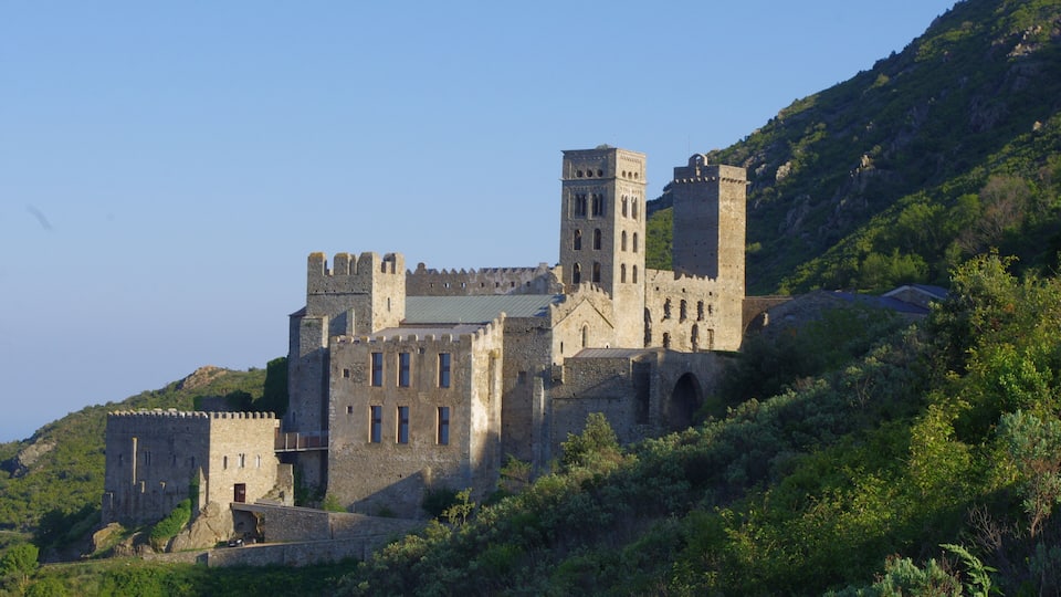 A historic castle on a hill with multiple towers and a fortified wall.