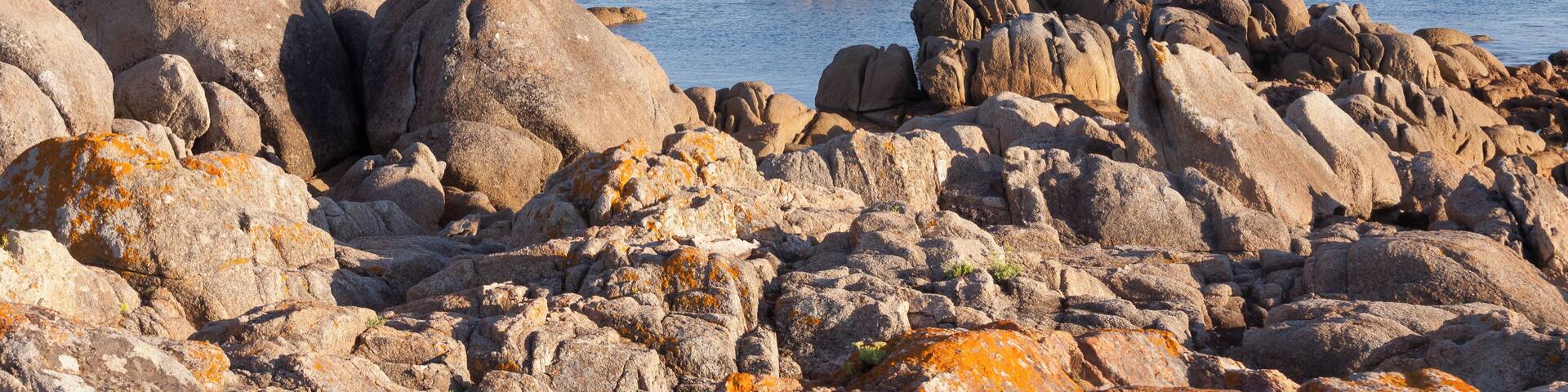 Sea and rocks in the ria of Pontevedra. Ons island at background. San Vicente do Mar, O Grove, Galicia, Spain.