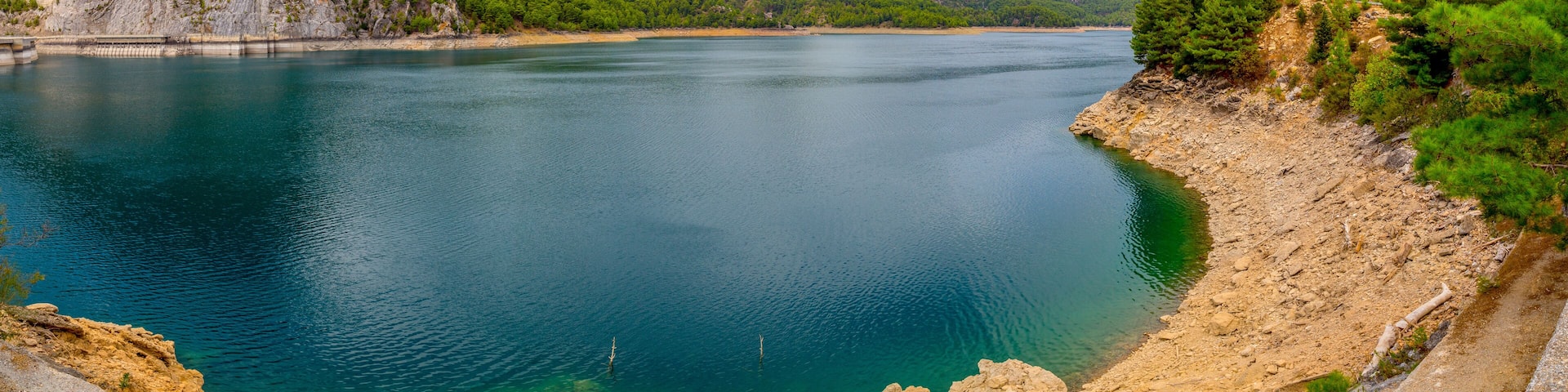 Green Canyon - one of the main attractions of Turkey. Natural beauty of Turkey. Mountains, green pines, turquoise lake. Mountain landscape with forest, trees. Beautiful mountain lake backround. Rocks.