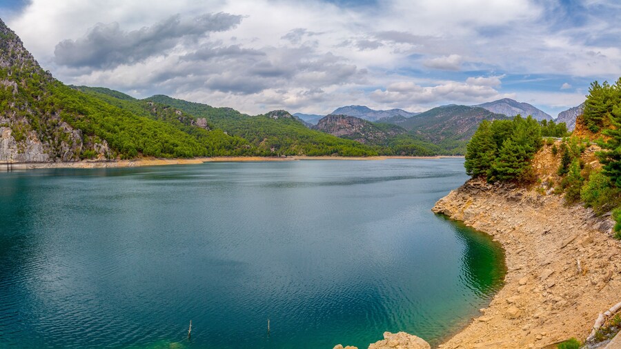 Green Canyon - one of the main attractions of Turkey. Natural beauty of Turkey. Mountains, green pines, turquoise lake. Mountain landscape with forest, trees. Beautiful mountain lake backround. Rocks.