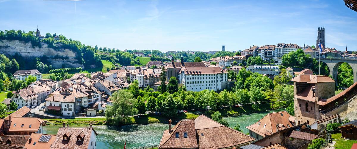 A town with a river, historic buildings, and a bridge.