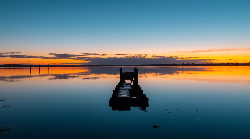 Old broken pier in the middle of lake at Gorokan, Australia.