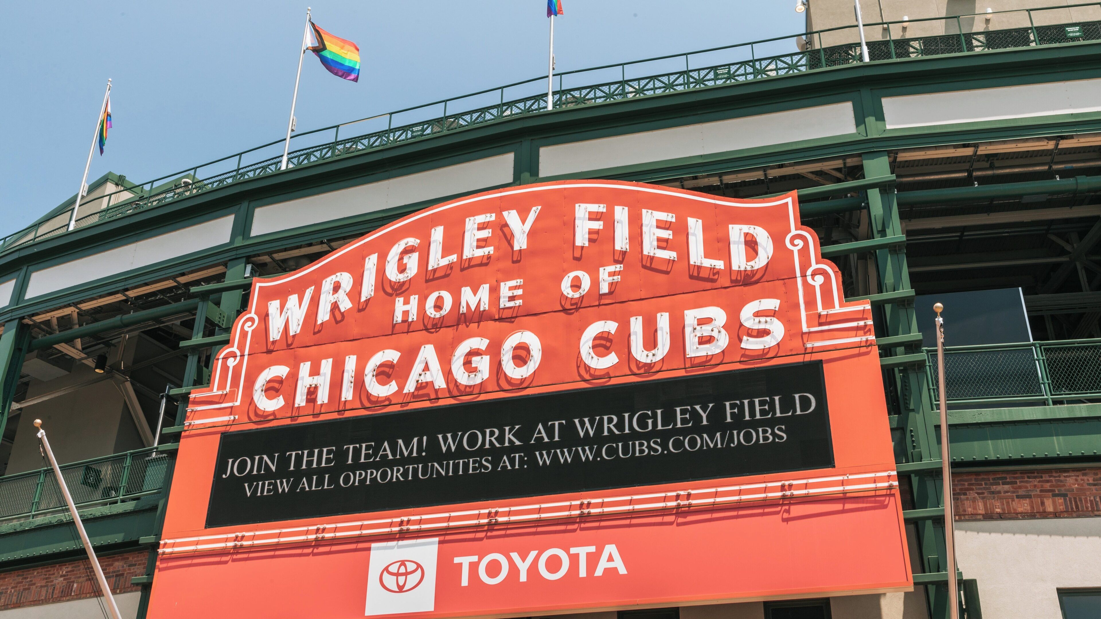 Wrigley Field showcases vibrant atmosphere and iconic marquee in Lakeview, Chicago during a sunny afternoon in spring