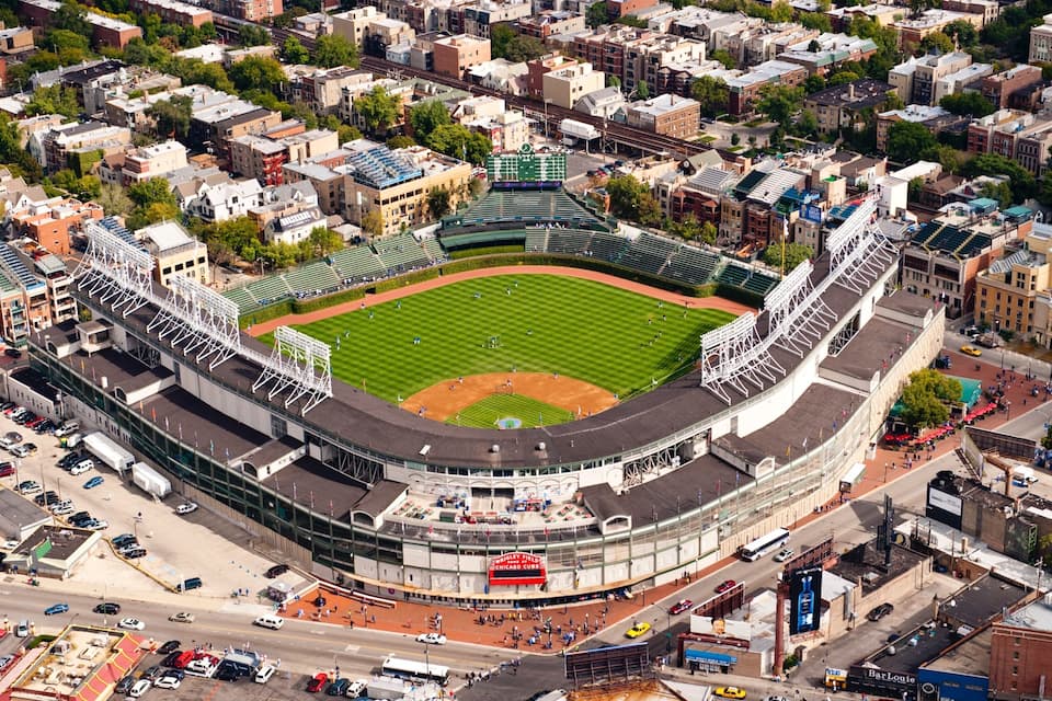 An aerial view of a baseball stadium surrounded by urban buildings.