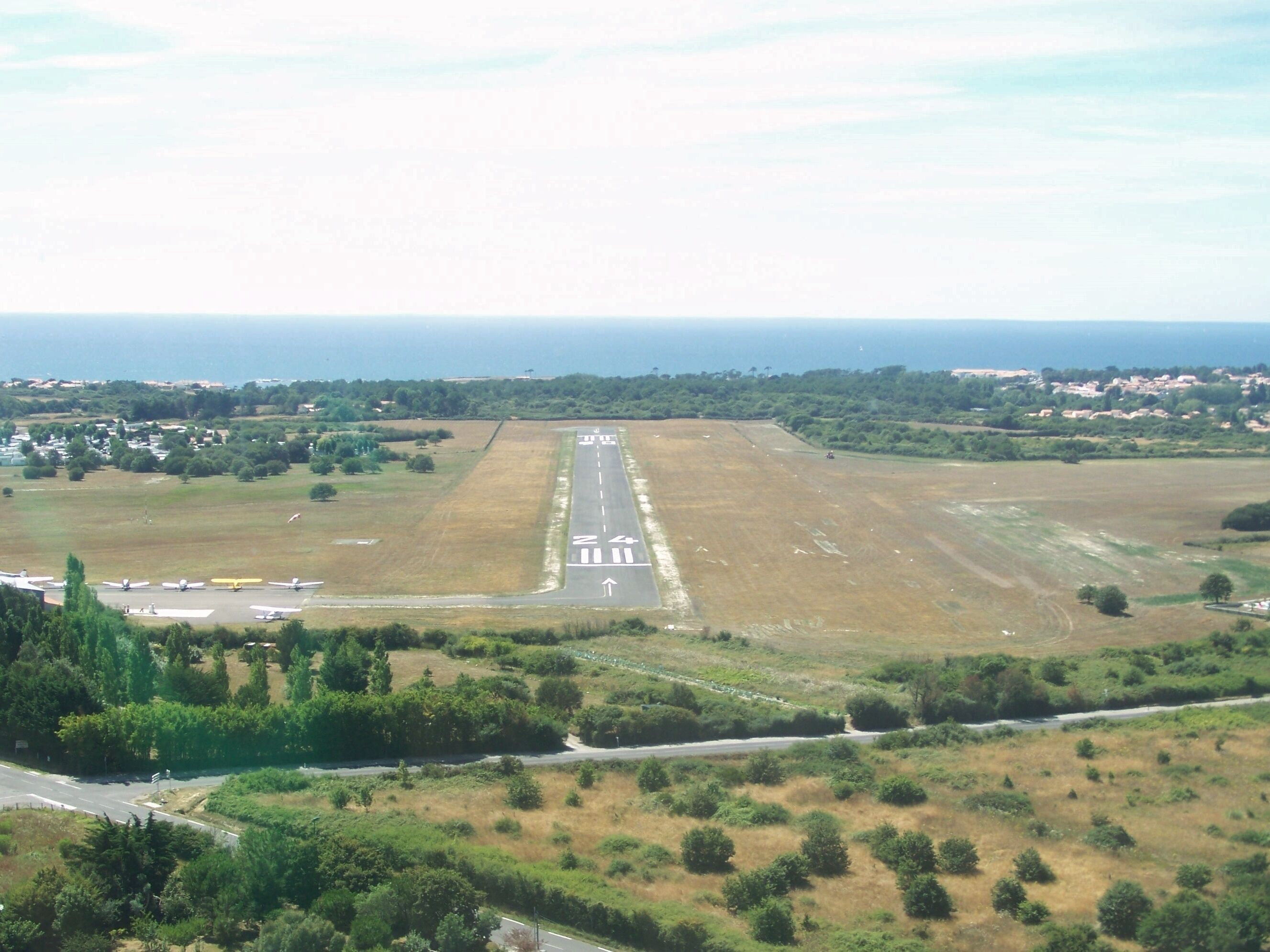 Sight on the single runway of Les Sables - Talmont airport, situated close to the Atlantic ocean (background) near les Sables d'Olonne in Vendée, France.