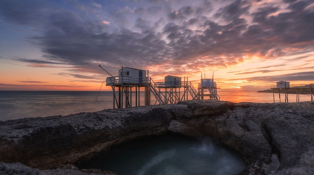 Sunset landscapes at the coastline of Saint-palais-sur-mer, with traditional carrelets along the sea in Charente-Maritime, France