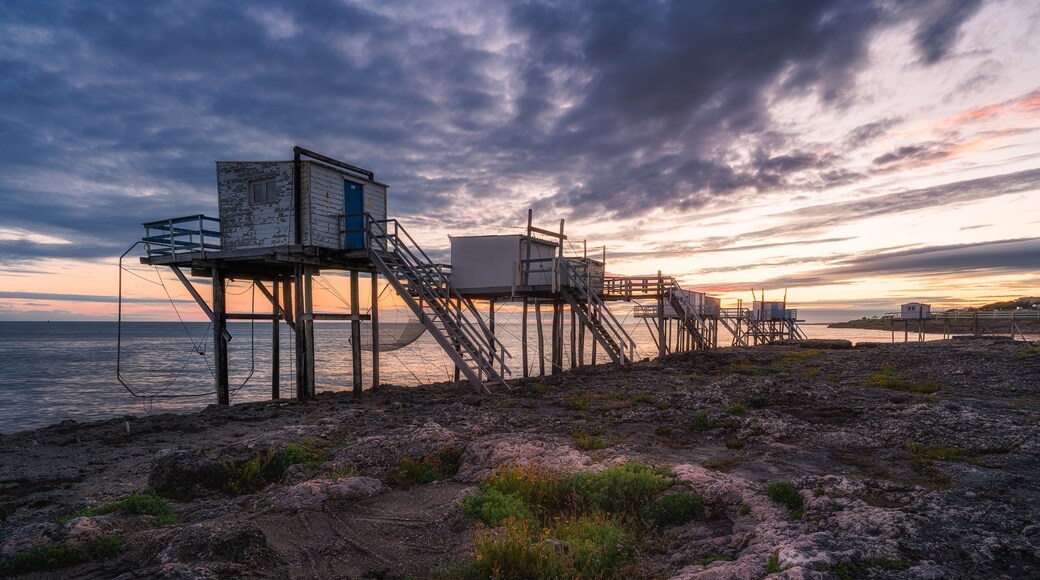 Sunset landscapes at the coastline of Saint-palais-sur-mer, with traditional carrelets along the sea in Charente-Maritime, France