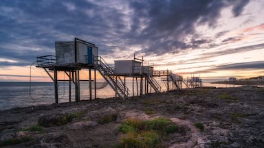 Sunset landscapes at the coastline of Saint-palais-sur-mer, with traditional carrelets along the sea in Charente-Maritime, France