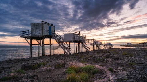 Sunset landscapes at the coastline of Saint-palais-sur-mer, with traditional carrelets along the sea in Charente-Maritime, France