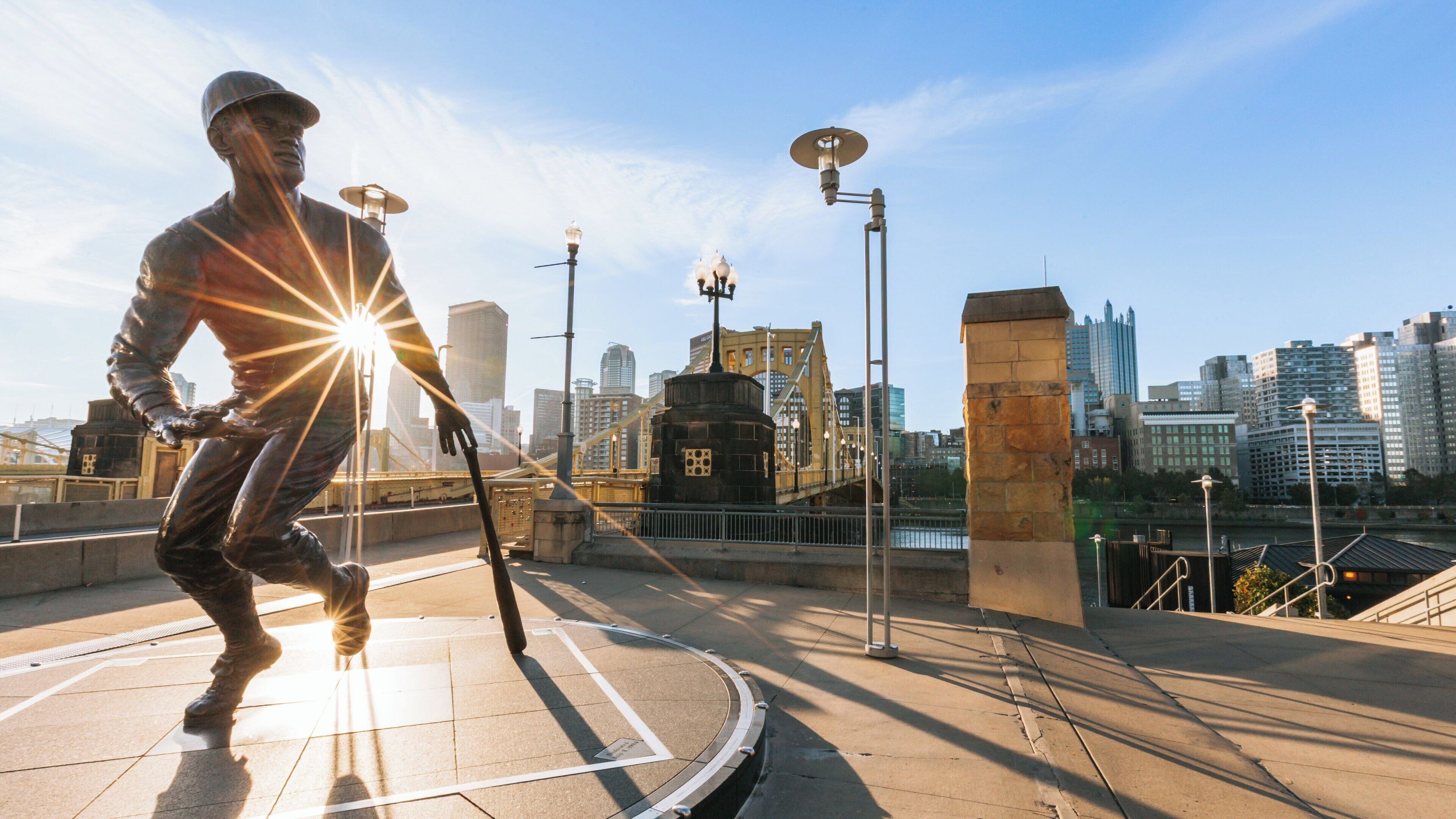 Stunning view of PNC Park with city skyline and statue at sunset in Downtown Pittsburgh, Pennsylvania
