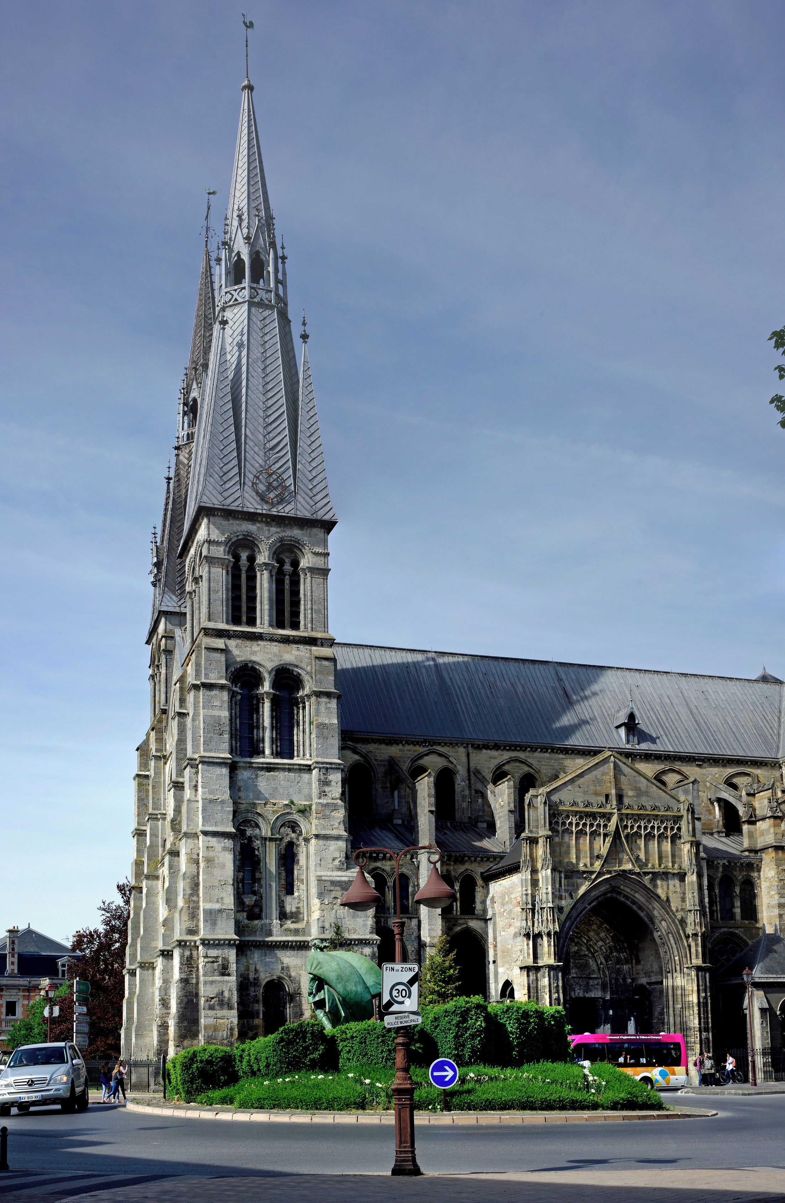 A historic cathedral with a tall spire and intricate stonework.