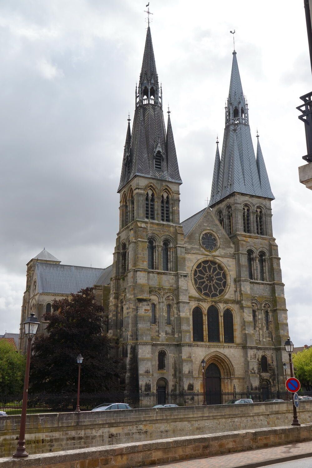 A historic cathedral with two tall spires and a large rose window.
