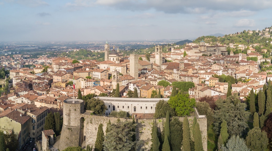 Drone aerial view of Bergamo - Old city (upper town), Italy. Landscape on the city center, the old fortress and its historical buildings during a wonderful blu day
