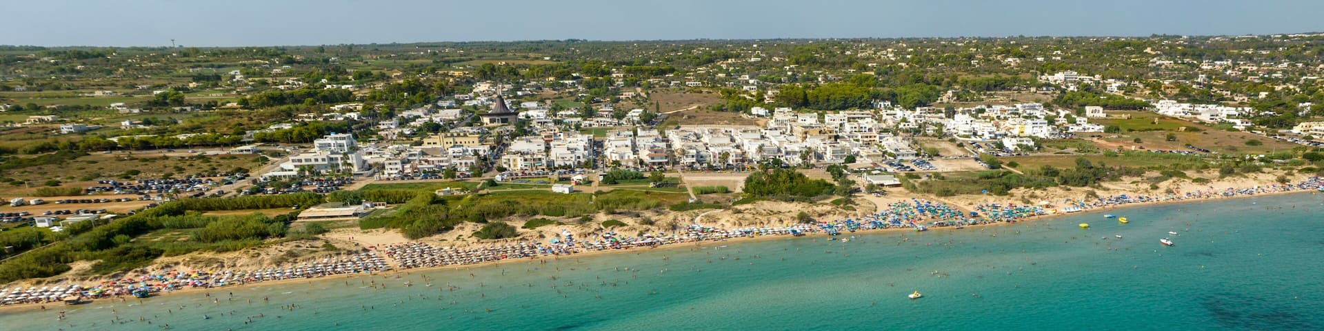 Panoramic aerial view of Pescoluse beach in Salento, Puglia, Italy. It is a hamlet of Salve and a seaside village with many holiday homes and villas. This beach is also called the Maldives of Salento.
