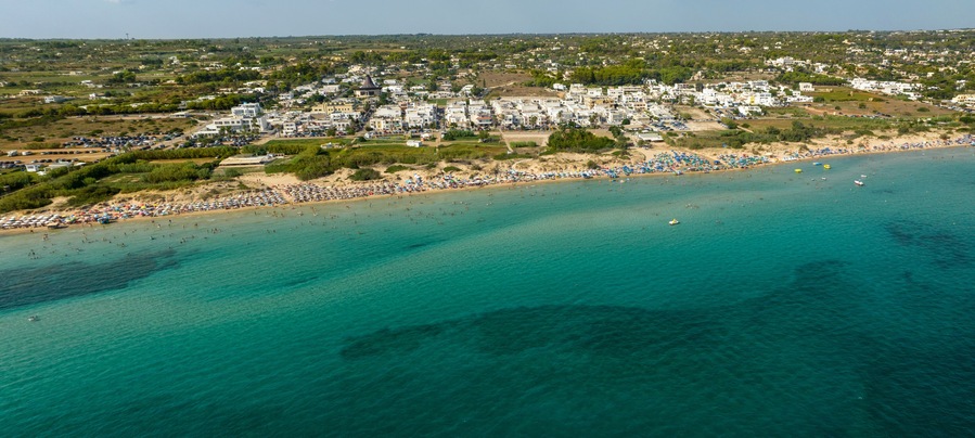 Panoramic aerial view of Pescoluse beach in Salento, Puglia, Italy. It is a hamlet of Salve and a seaside village with many holiday homes and villas. This beach is also called the Maldives of Salento.