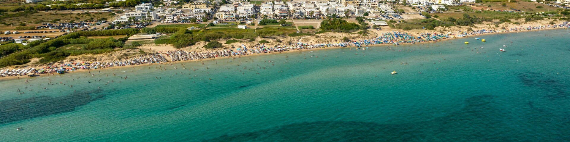 Panoramic aerial view of Pescoluse beach in Salento, Puglia, Italy. It is a hamlet of Salve and a seaside village with many holiday homes and villas. This beach is also called the Maldives of Salento.