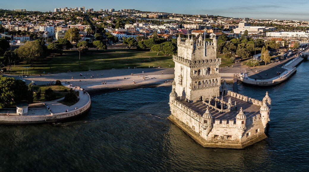 Aerial drone photo of the Belem Tower (Belém Tower) at sunset. A medieval castle fortification on the Tagus river of Lisbon Portugal