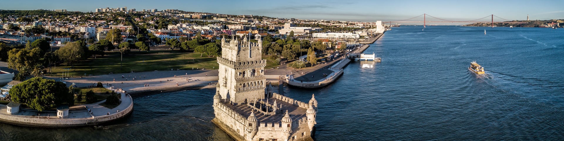 Aerial drone photo of the Belem Tower (Belém Tower) at sunset. A medieval castle fortification on the Tagus river of Lisbon Portugal