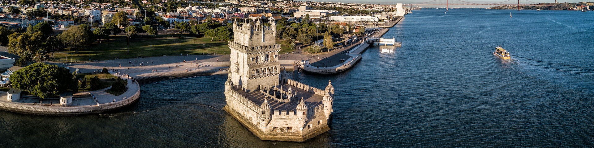 Aerial drone photo of the Belem Tower (Belém Tower) at sunset. A medieval castle fortification on the Tagus river of Lisbon Portugal