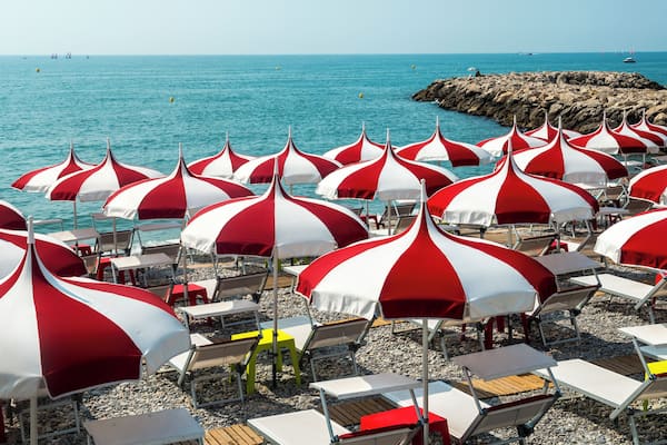 Cagnes-sur-Mer (Alpes-Maritimes, Provence-Alpes-Cote d'Azur, France), red and white umbrellas on the beach