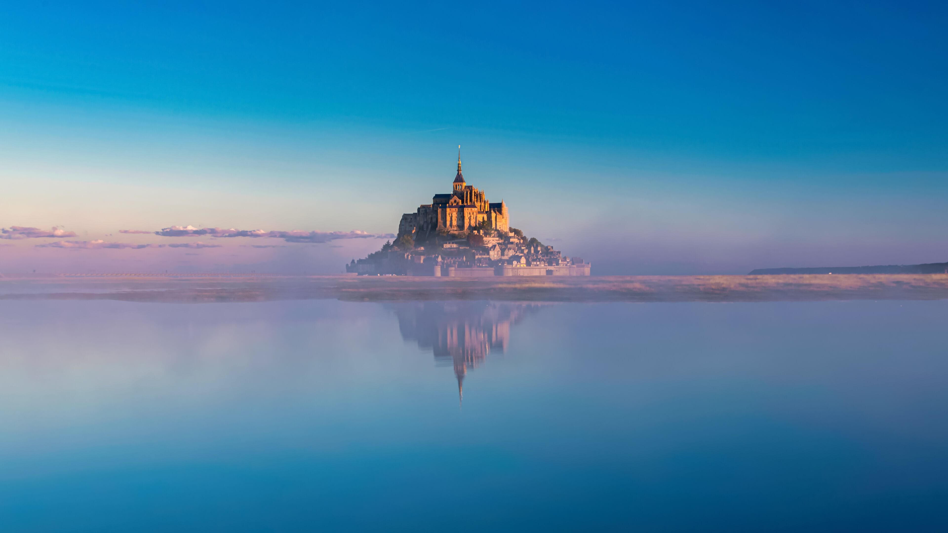 Breathtaking sunrise at the famous Le Mont Saint-Michel tidal island , Normandy, France
