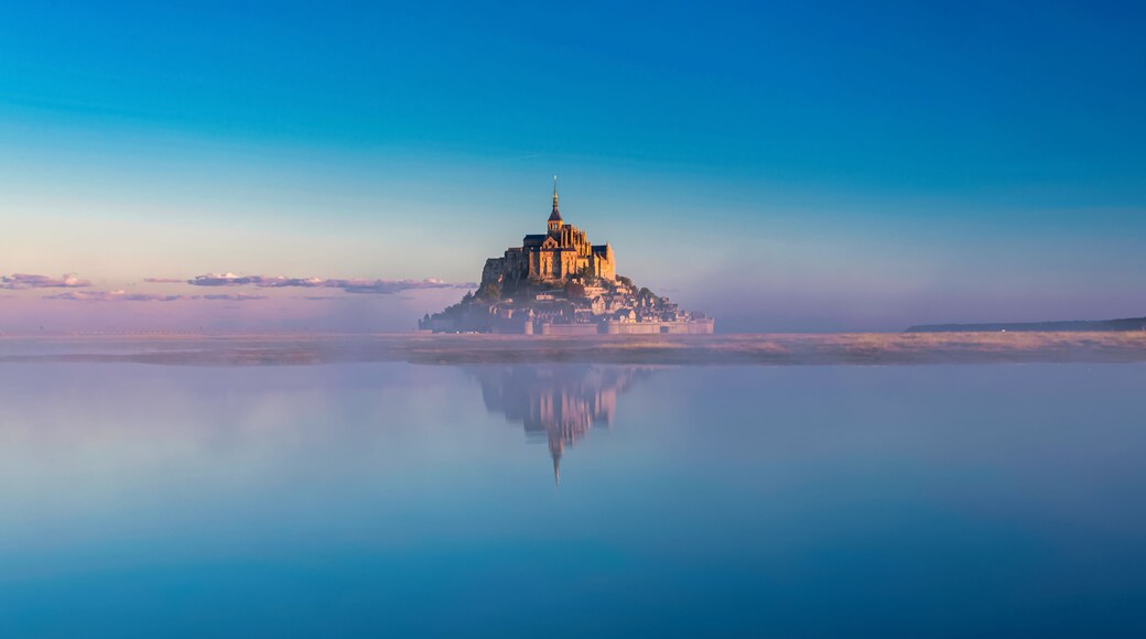 Breathtaking sunrise at the famous Le Mont Saint-Michel tidal island , Normandy, France