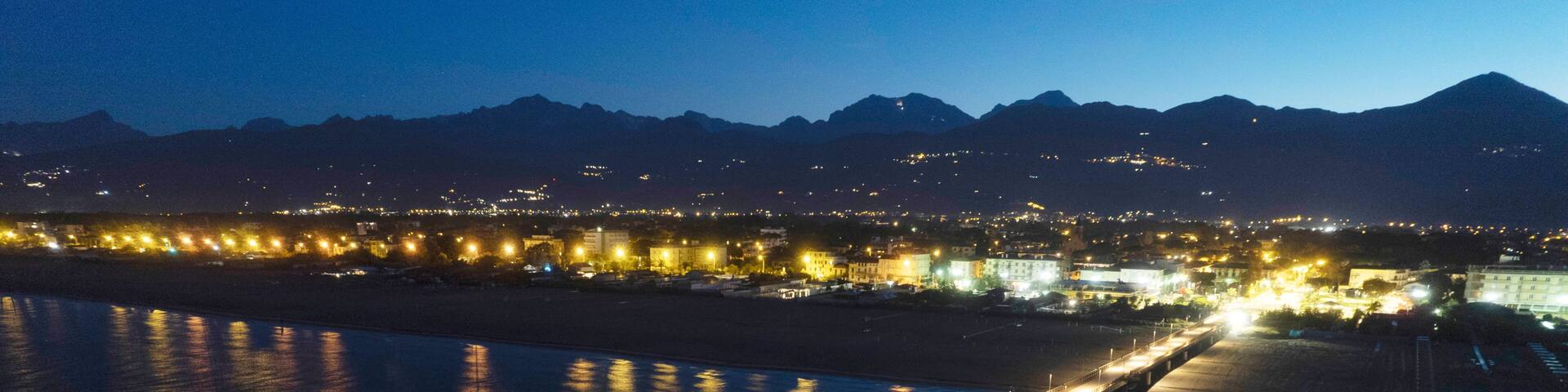 Night aerial view of the pier of Marina di Pietrasanta Tuscany Italy
