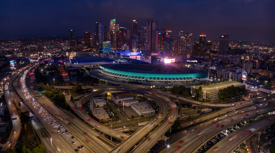 JANUARY 2024, LOS ANGELES, CA. - aerial view of LA Skyline & Convention Center at dusk showing intersection of Harbor Freeway 110 and Interstate Highway 10 with traffic