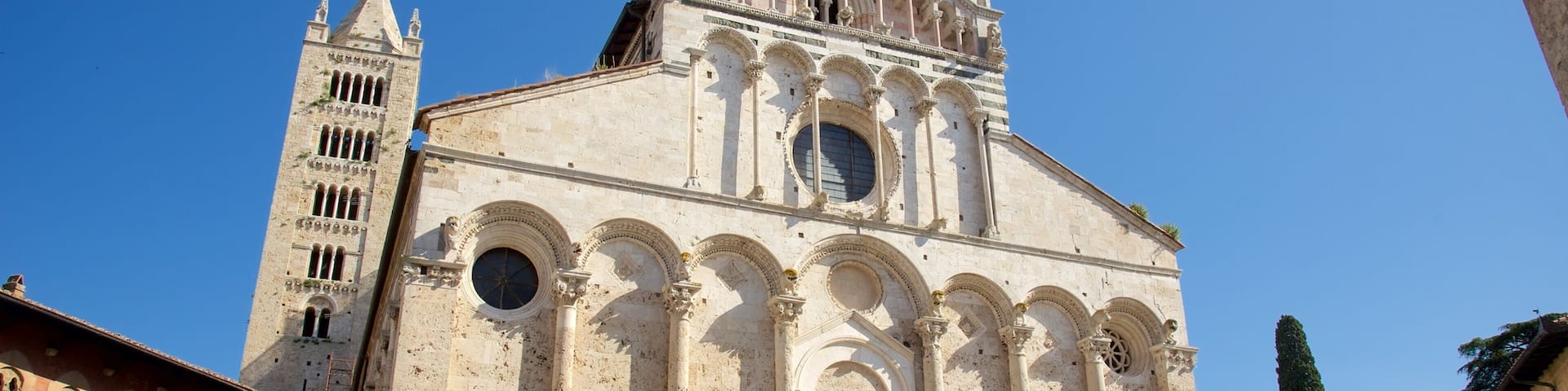 A historic cathedral with a tall bell tower and a large central dome.