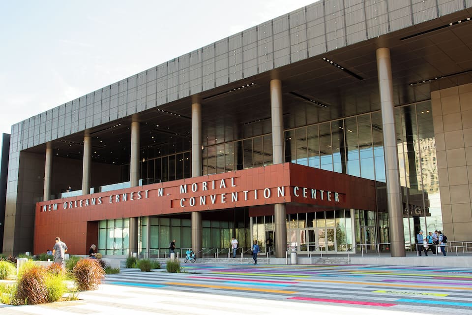 The exterior of the New Orleans Ernest Mortimer Convention Center with large columns and a modern design.